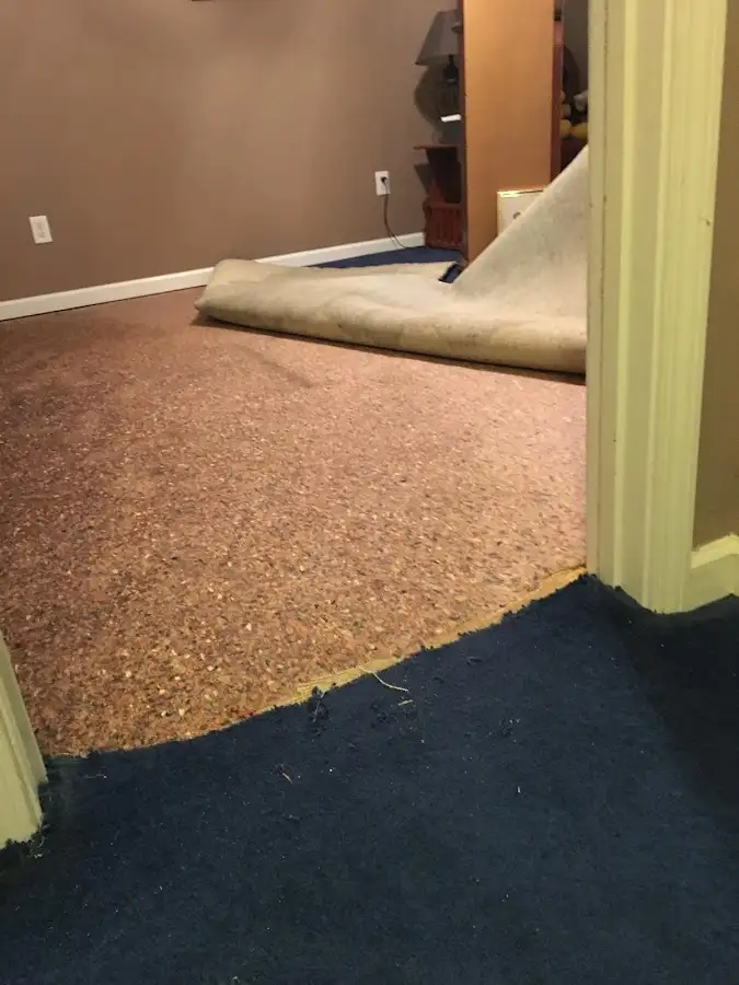 Carpet pad removal revealing water damage during Drying & Dehumidification in West Des Moines